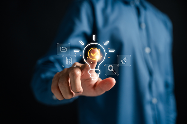 hand pointing at a lightbulb